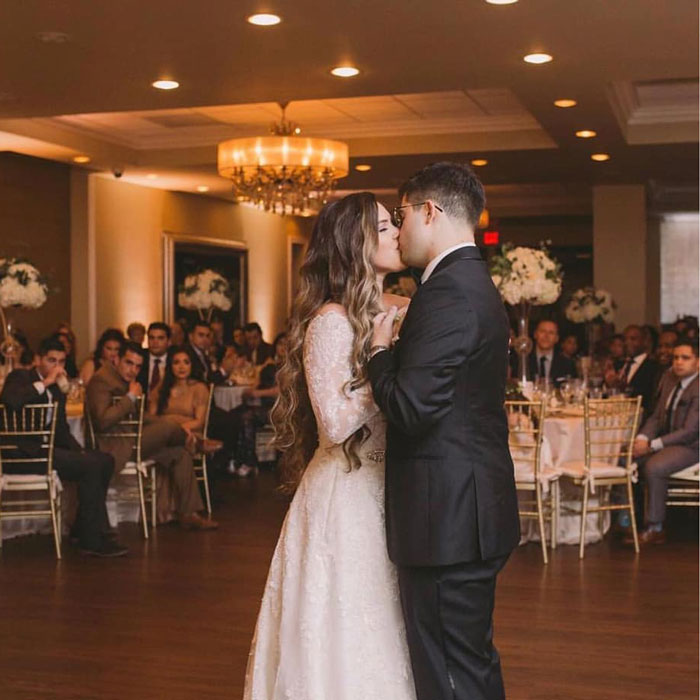 bride and groom kissing in the ballroom