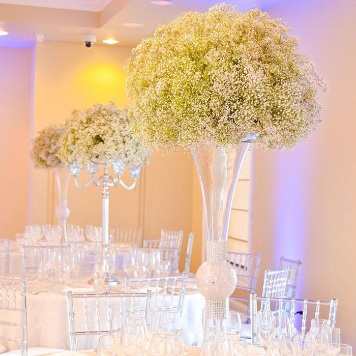 tall floral centerpiece on table