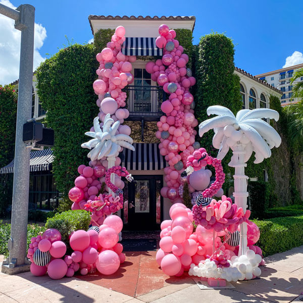 pink and white balloons outside entrance to event venue